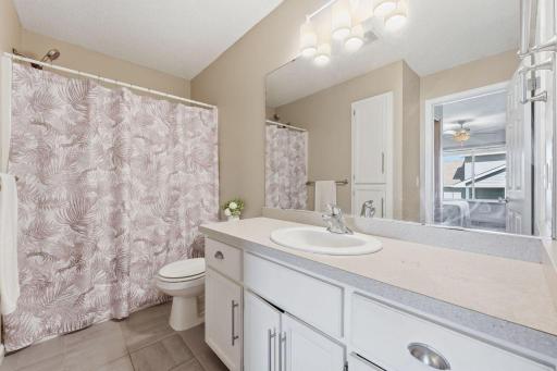 The bright full bathroom is complete with a tub/shower combo, linen closet, and plenty of lighting.