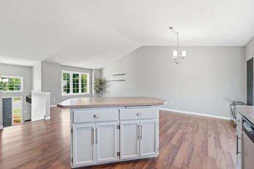 Center island has additional cabinet space and room for bar stools.