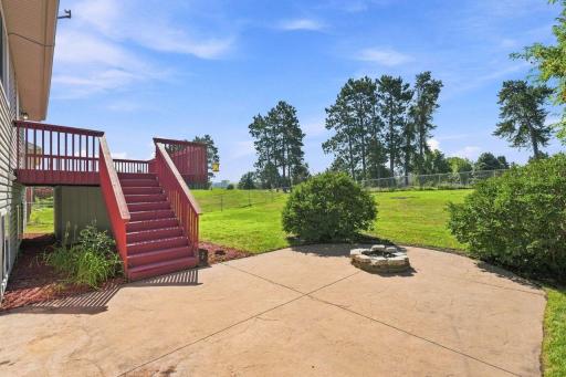 Grab your lawn chair, kick back, and enjoy relaxing summer evenings around the backyard firepit. Nice stamped concrete patio.