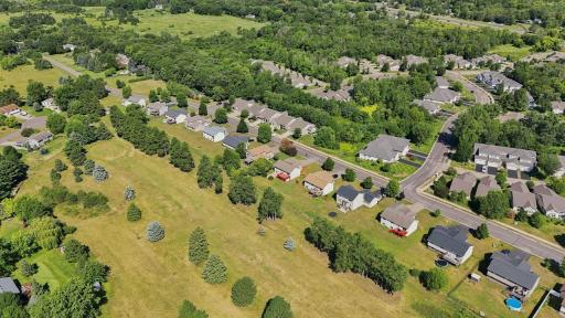 The homes are all nicely spaced apart and show off mature trees.