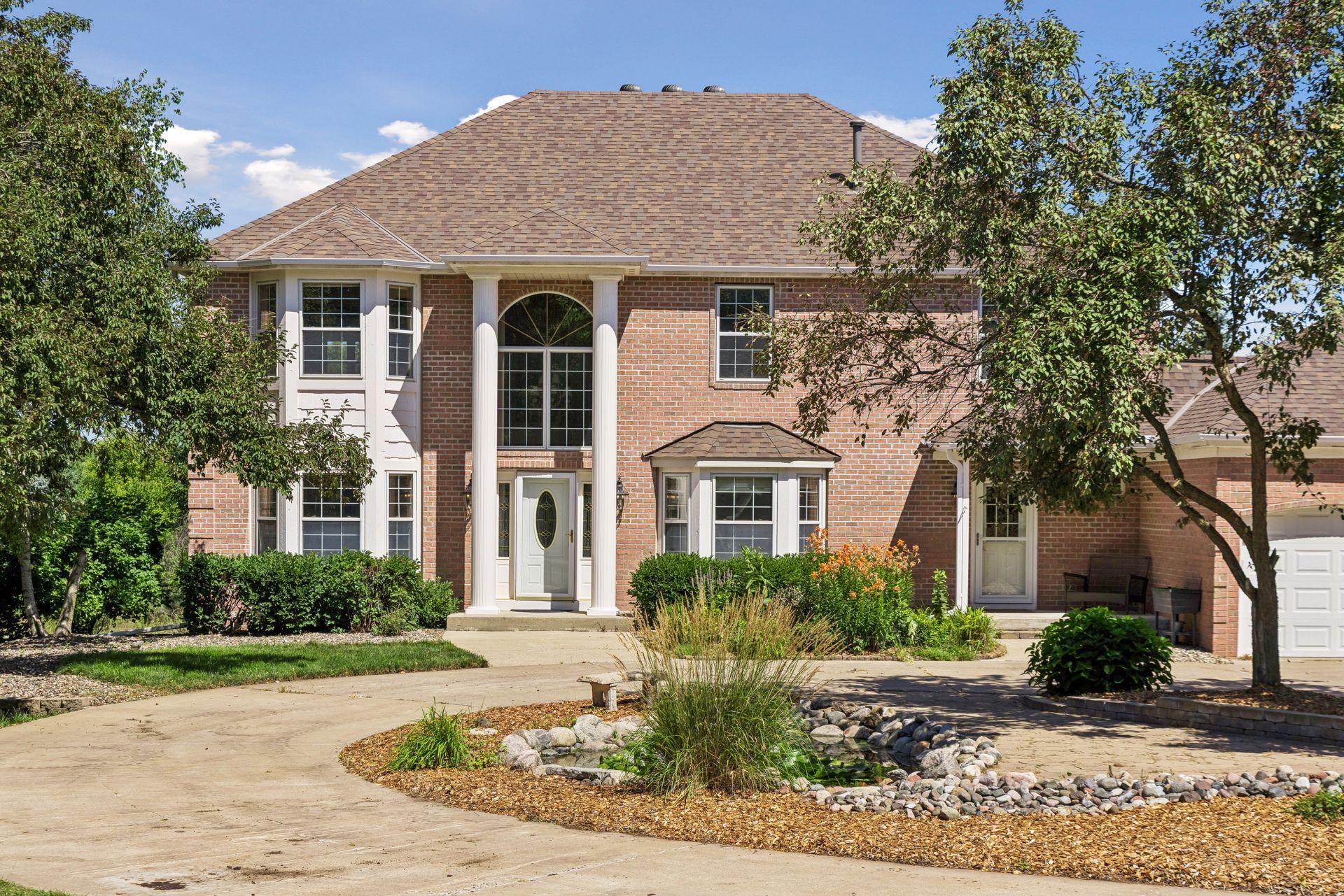 A beautiful front approach featuring a new roof in 2025 and a charming waterfall feature that creates a peaceful welcome home.
