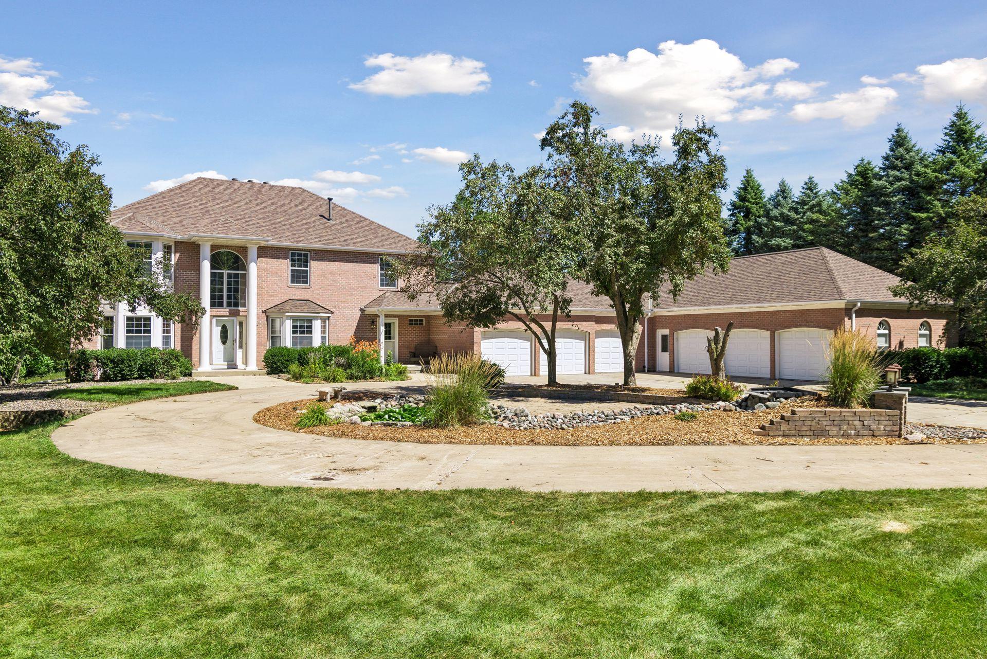 What an entrance! This impressive home features a beautiful circular driveway, brick exterior and an incredible 6-car attached garage—all set on nearly 7 acres.