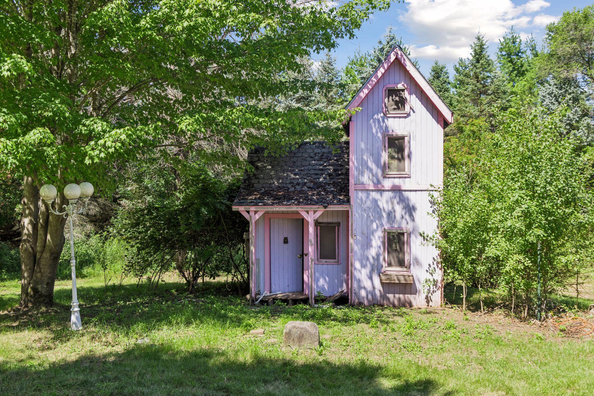 How charming is this? With a little TLC, the existing playhouse could once again become an adorable backyard hideaway and a special place for imaginative play.