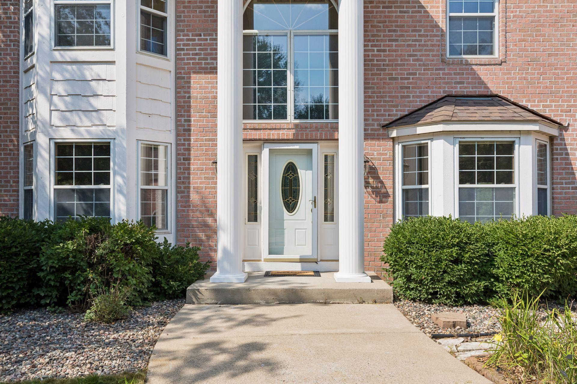 The impressive front entrance makes a statement with soaring height, the columns and expansive windows—a welcoming first glimpse of what awaits inside.