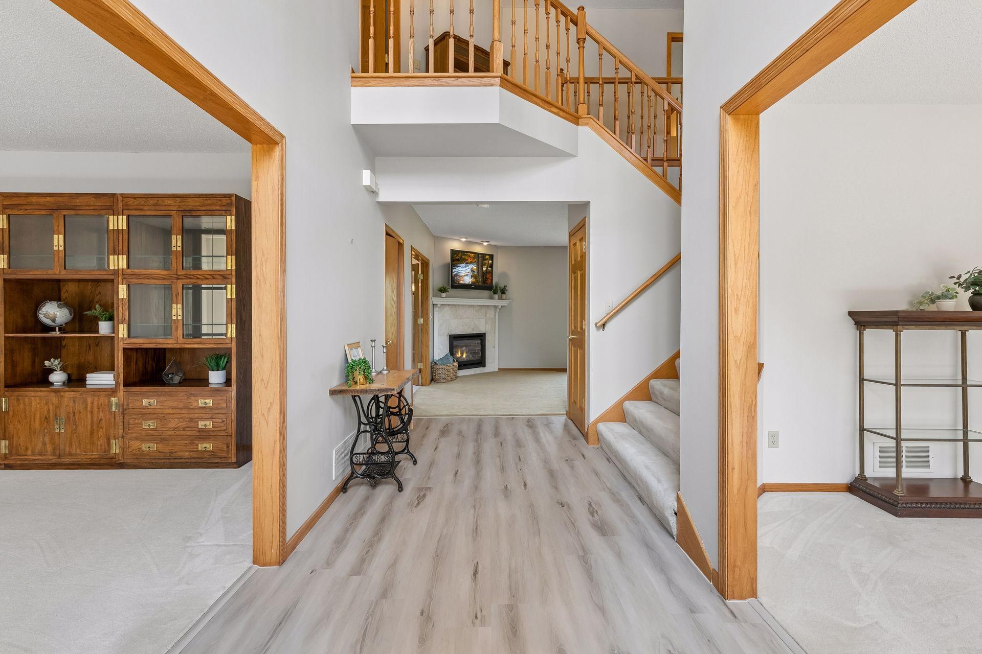 Flexible spaces flank the entry—a sitting room or future home office to the left and a formal dining room to the right, complete with a convenient swinging door to the kitchen.