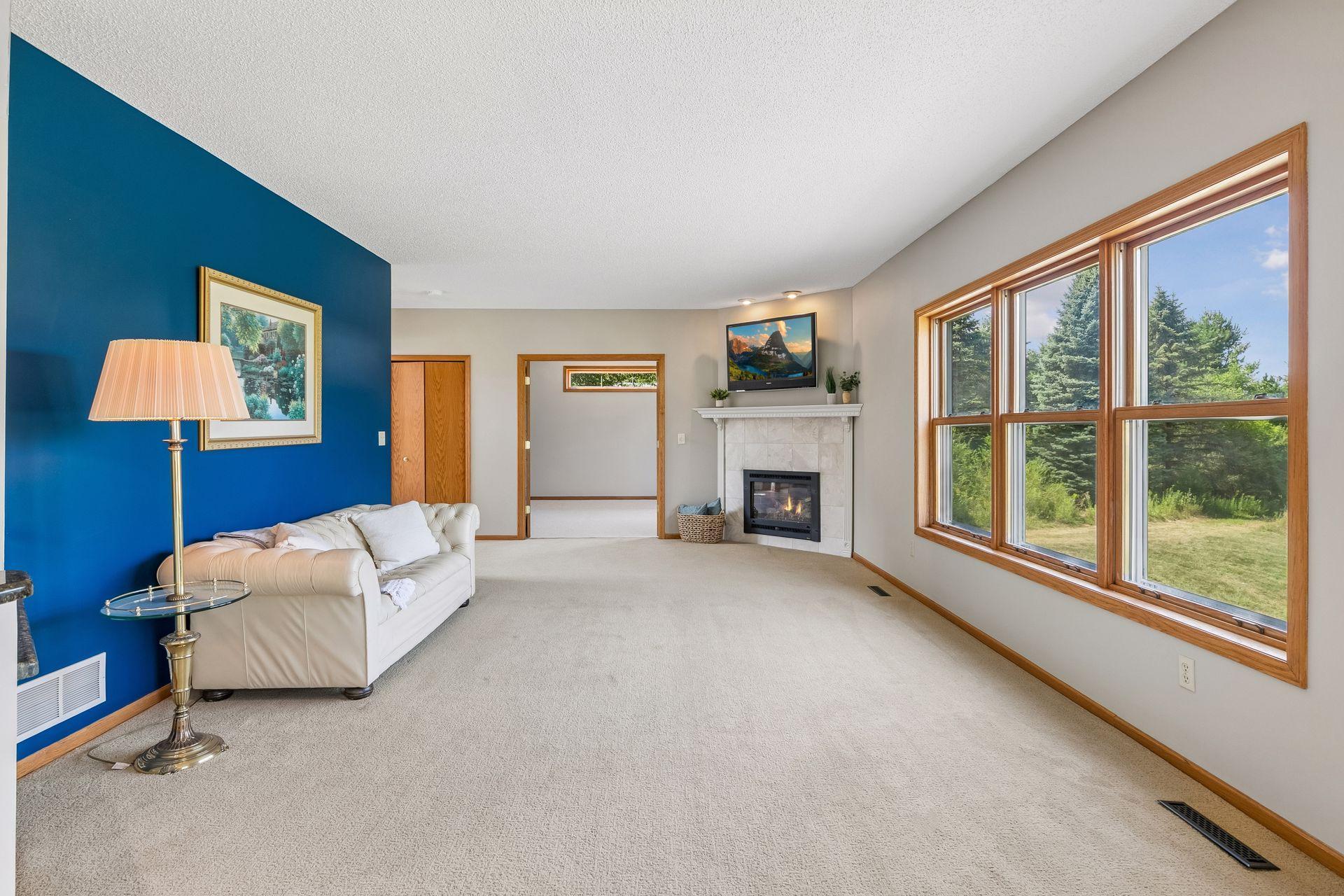 Welcome to the main-floor family room, where large windows frame a gorgeous view of the backyard and nearly 7-acre setting.
