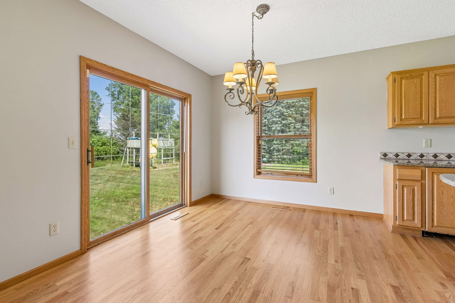 Another view of the kitchen dining area, with access ready for a future deck overlooking the backyard and acreage.