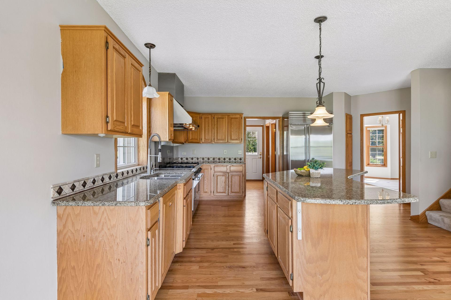 A kitchen made for cooking and gathering, with an abundance of cabinetry, expansive counter space and a large center island.