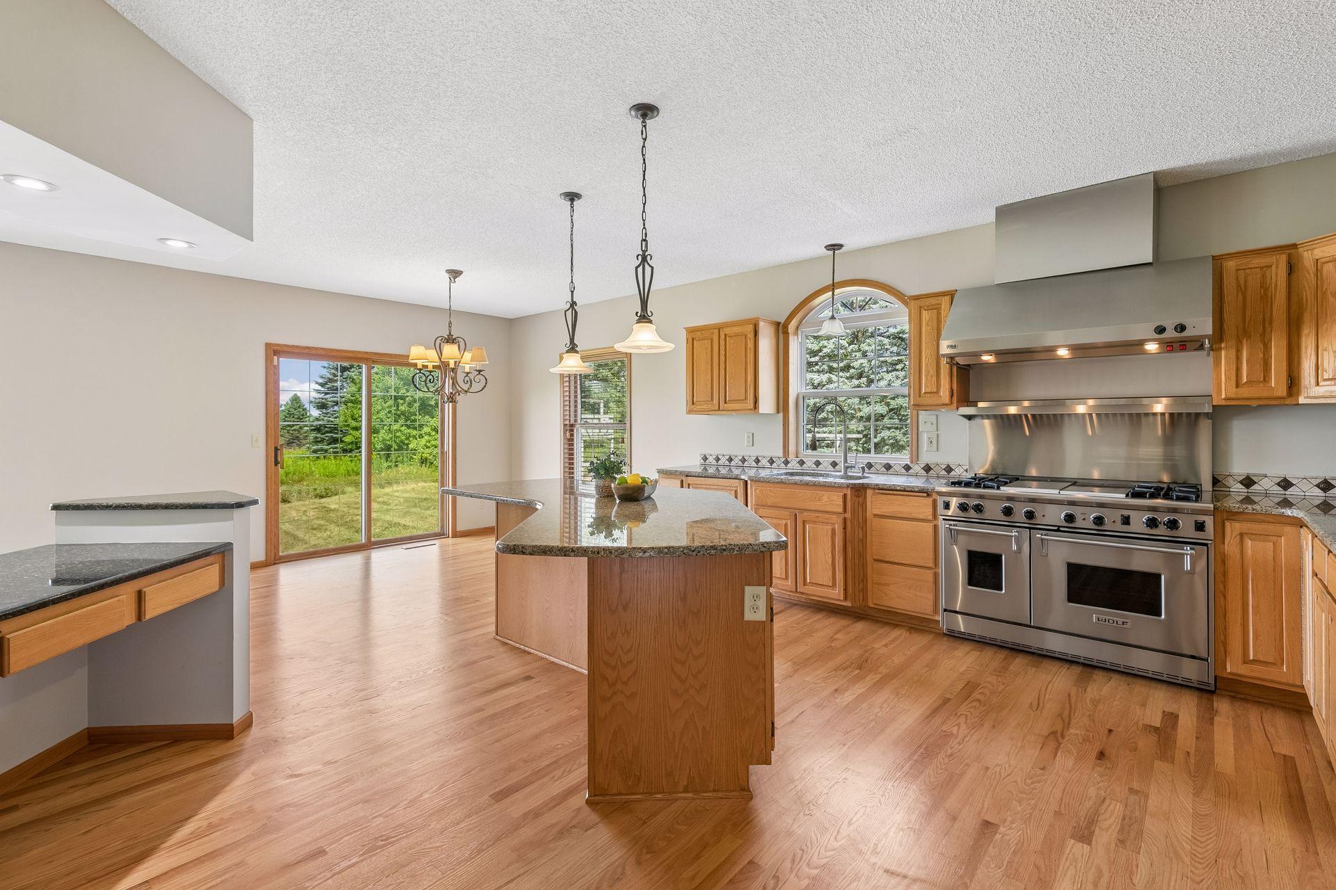 The recently refinished hardwood floors shine throughout the kitchen and add warmth to this inviting main-level space.