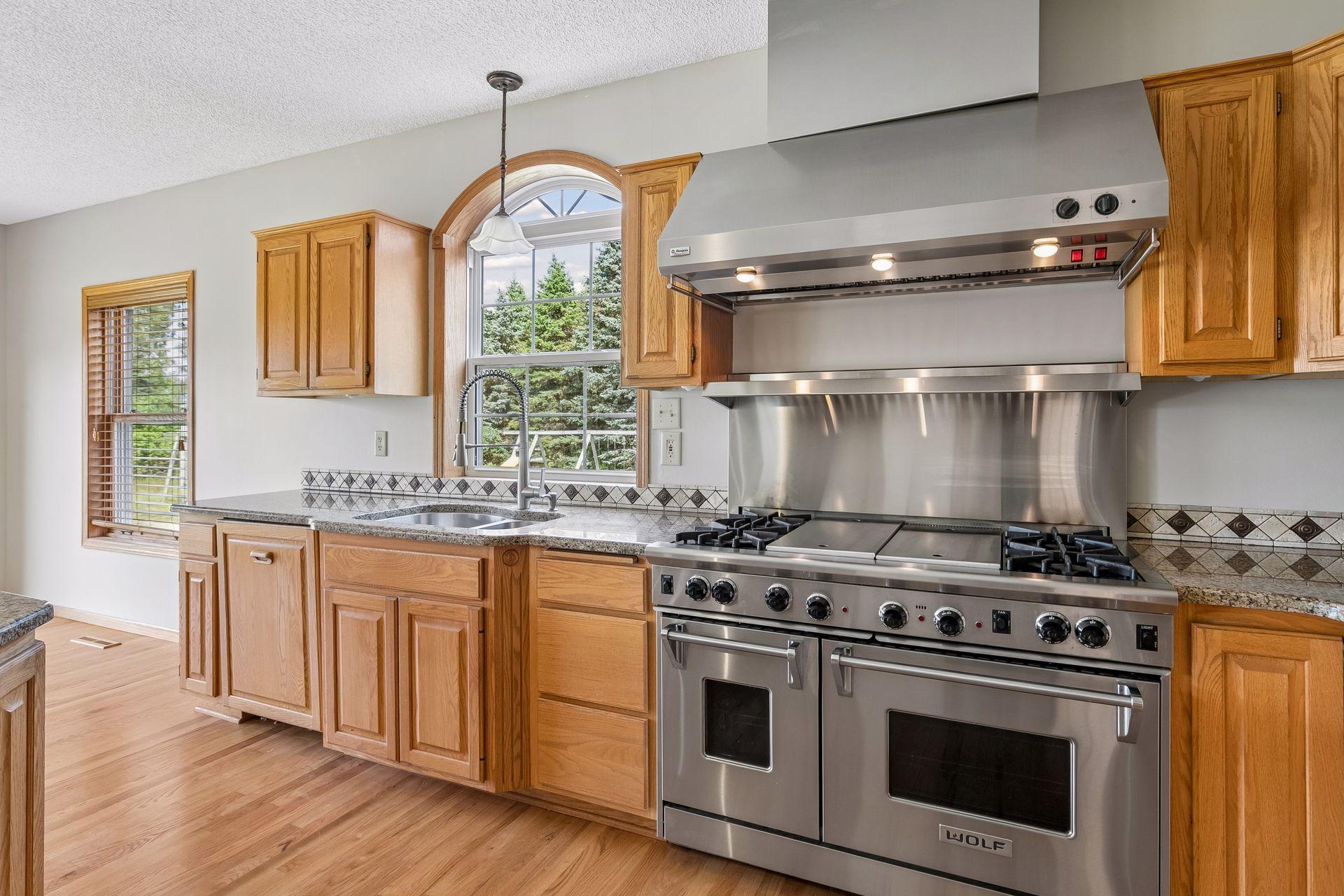 Another look at the Wolf gas range and thoughtfully designed workspace, conveniently positioned near the sink with plenty of prep space.