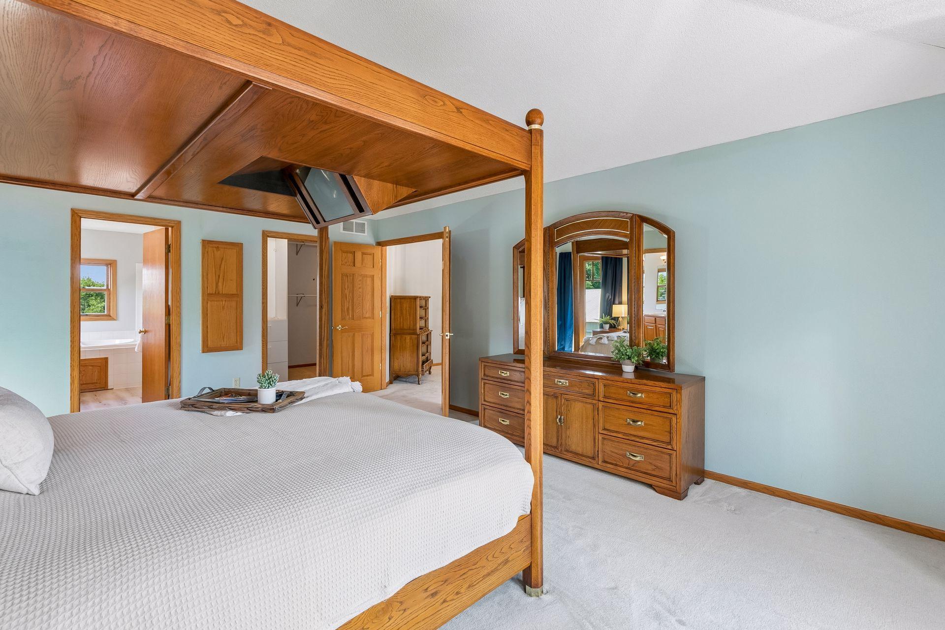 Another view of the generously sized primary bedroom, complete with a large walk-in closet and plenty of room for additional furniture or a sitting area.