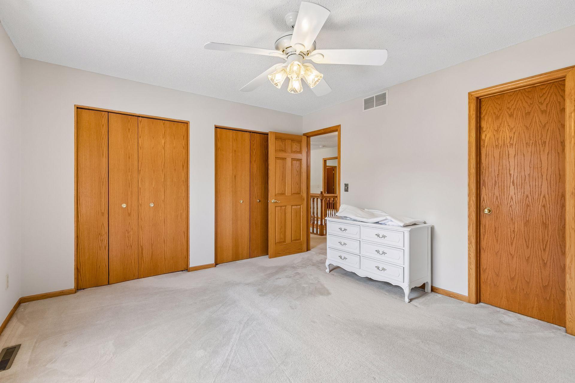 Another view of bedroom four showcases its generous size, natural light and flexible furniture layout.