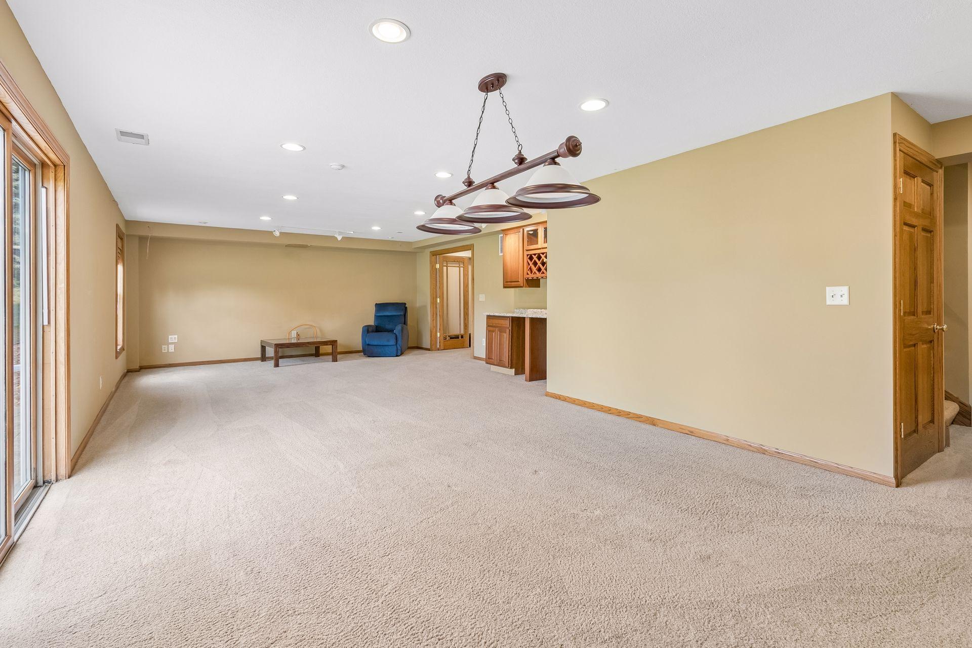 Game night, anyone? This oversized recreation room has plenty of space for a pool table, games, additional seating and more.