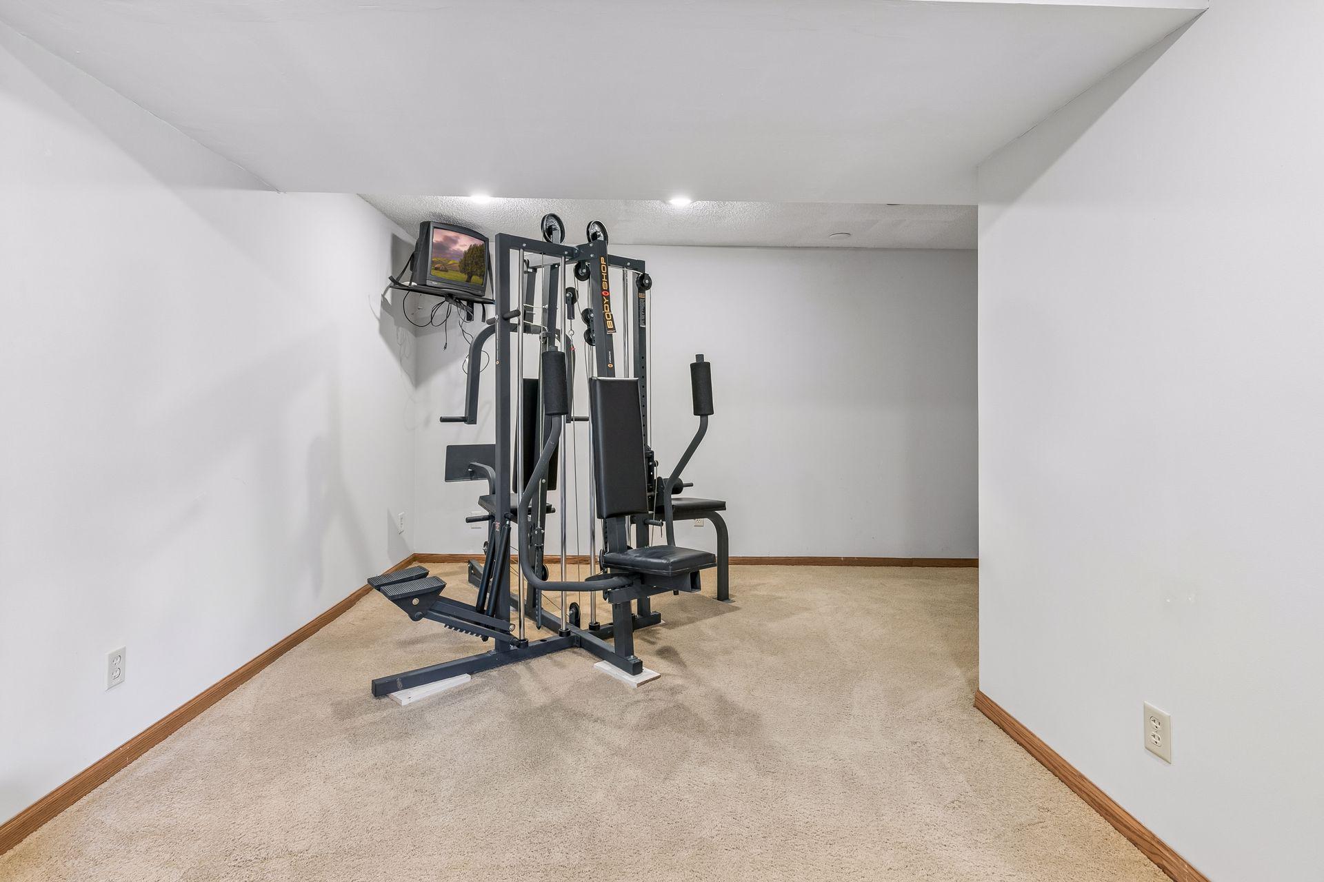 Tucked away from the main recreation space is a dedicated exercise room—perfect for your at-home workouts
