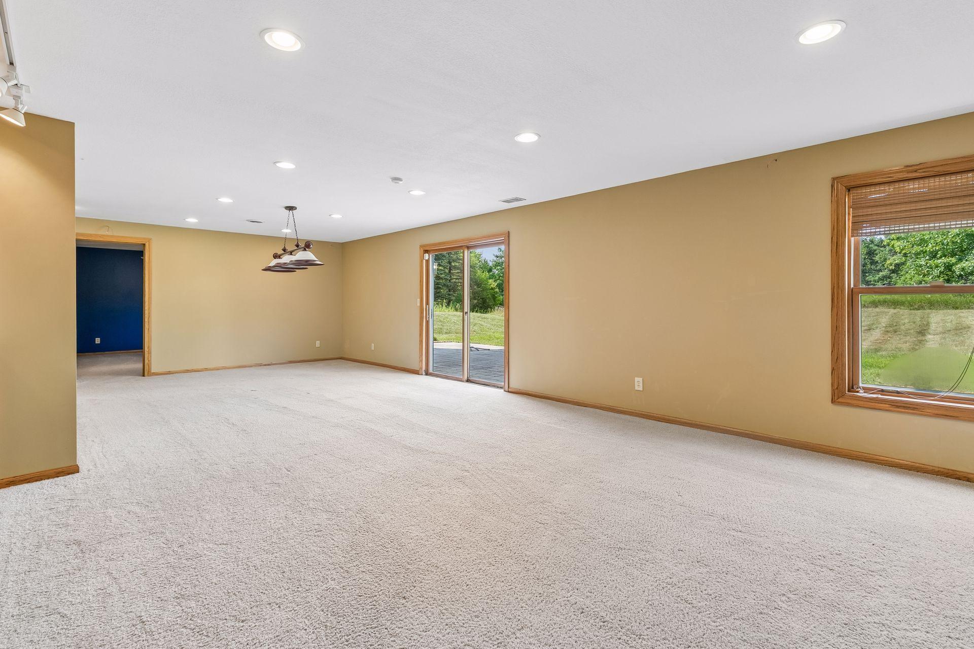Another view showcases just how spacious the walkout lower level is, with multiple areas for relaxing, entertaining and recreation.
