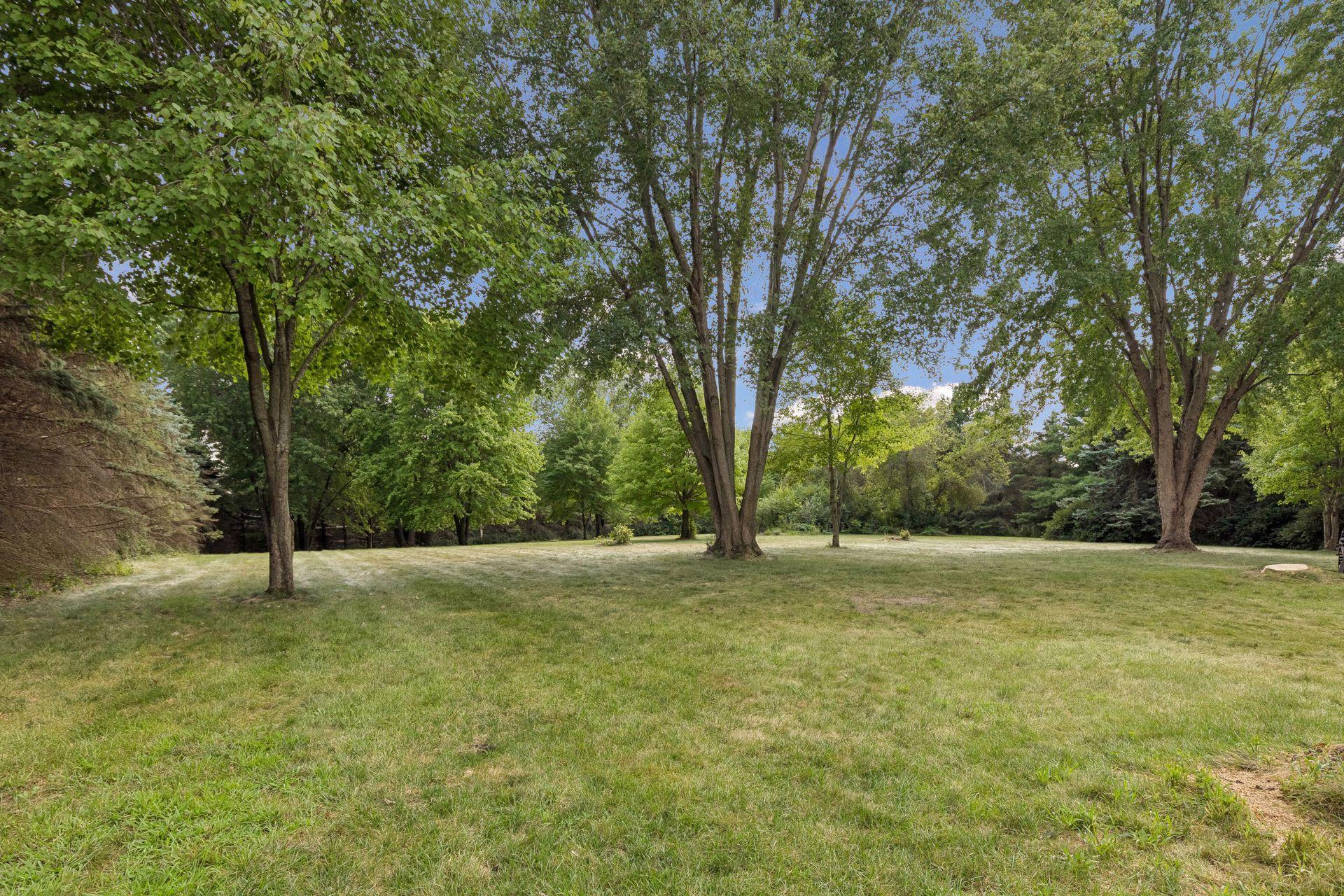 The expansive front lawn has been a favorite place to play, gather and enjoy the outdoors—an incredible green space surrounded by the beauty and privacy of nearly 7 acres.
