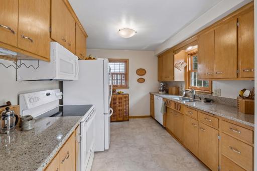 Spacious kitchen with updated appliances, quartz counter tops, new flooring and ample storage!