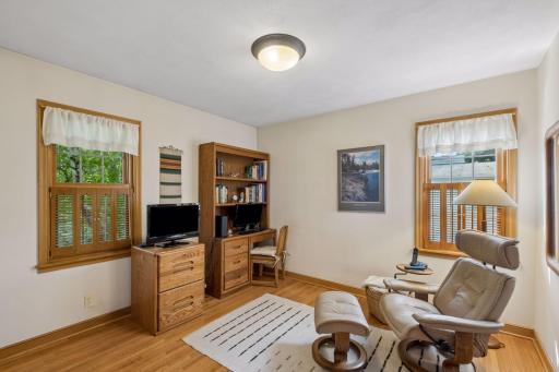 Second bedroom with original wood floors and two windows.