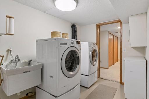 Lower Level Laundry Room with sink and additional storage!