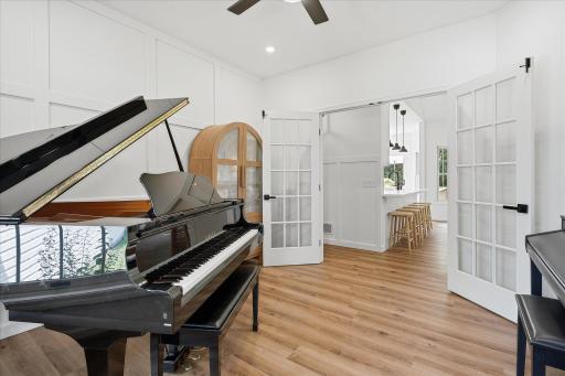 The room features two accent/feature walls, a ceiling fan with separate light/fan switches and four recessed lights.