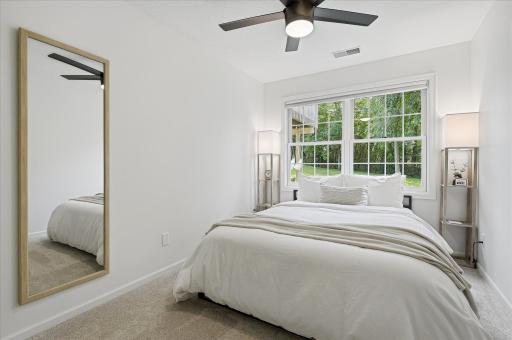 Bedroom #4 features a modern ceiling fan w/separate light & fan switches and modern & neutral paint & carpet.