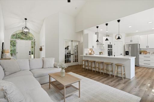 The living room is directly connected to both the foyer and the kitchen - and the French doors in the rear of this photo leads to a den/home office OR formal dining room. The current owners are using it as a piano room.