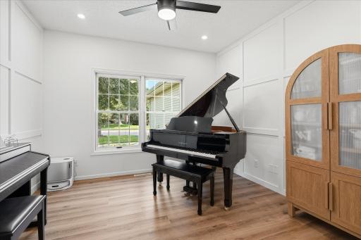 This "flex room" can be used as a dining room, a home office, a TV room or like these owners do, you can use it as a piano room too!