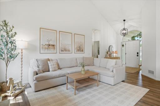 After passing through the bright & cheerful foyer, you'll find yourself in this stunning & bright living room.