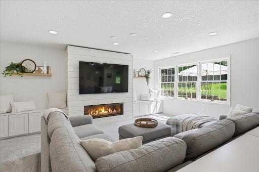 The shiplapped fireplace wall surrounds your modern, linear fireplace and the fireplace has a thermostatic remote control.