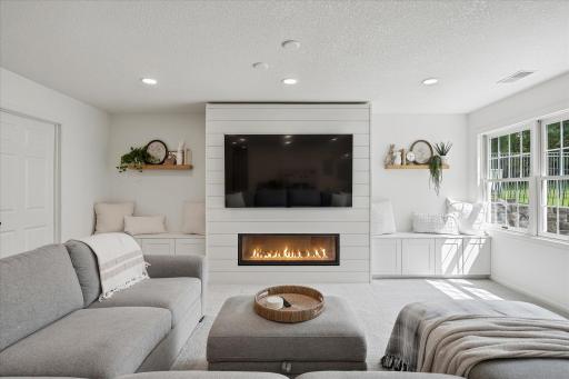 The cabinets on each side of the fireplace are great for storing games, movies, books and A/V components. The floating shelves are included too!