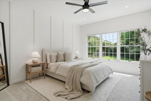 The primary bedroom is huge and features a board & batten feature wall, a ceiling fan with separate light & fan switches, recessed lights and room darkening honeycomb shades.