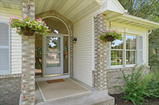 As we approach the front door, we are greeted by a covered entry, and we should note that there is a 3/4 light Larson screen/storm door to let the breeze in!