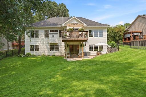 The back yard has such a great balance of sun & shade, and all those big windows are just storybook beautiful!