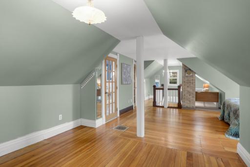 Primary bedroom with refinished wood floors