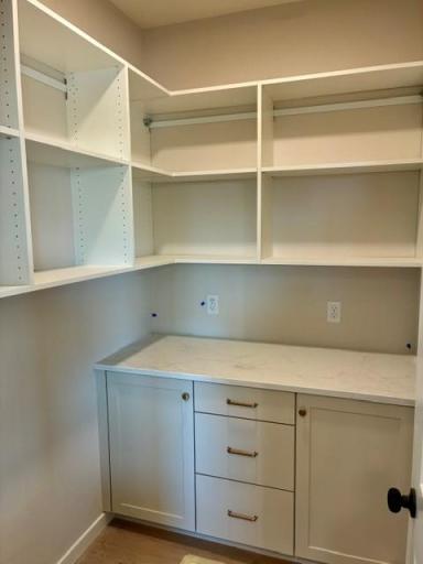 Pantry with built in cabinets and solid shelving.jpg