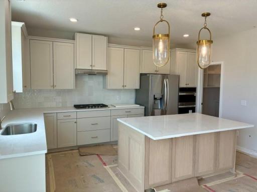 Gourmet kitchen with custom cabinets, enlarged island, gas cooktop and built in oven-micro column 1.jpg
