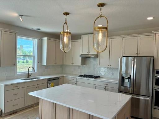 Gourmet kitchen with custom cabinets, enlarged island, gas cooktop and built in oven-micro column.jpg