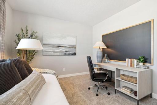 Tucked back off the home's mudroom, away from the hustle and bustle of the main level living spaces, this bedroom resides adjacent to a 3/4 bath & serves as the perfect guest room or your home office! Photo of a model home, color & options will vary.