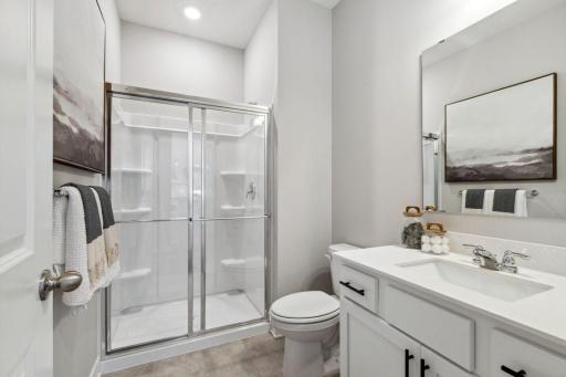 The main level 3/4 bath is located right off the owner's entry and main level bedroom - conveniently located for the entire household. Photo of a model home, color & options will vary.