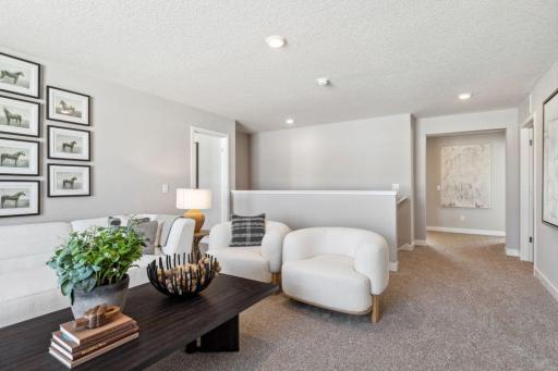 Once upstairs, the entire level flows from the focal point offered by this huge loft space. Sure to become a family favorite hangout spot! Photo of a model home, color & options will vary.