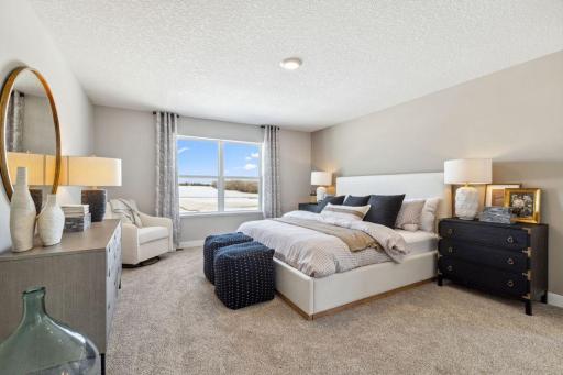 An oasis of its own, the primary suite offers the perfect escape. Windows will overlook the backyard, and there's immediate access to a private bathroom that features TWO walk-in closets!! Photo of a model home, color & options will vary.