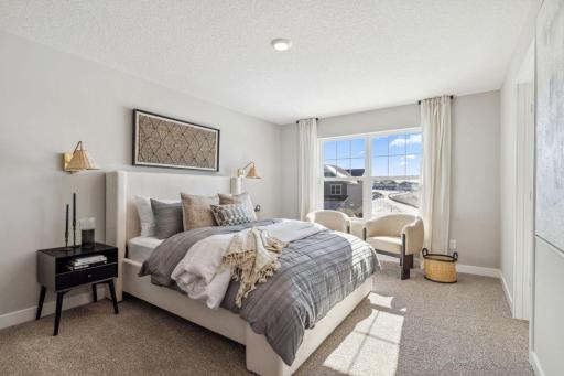 The 3rd secondary upper-level bedroom is the most spacious, and has it's own 3/4 bathroom (not attached). Photo of a model home, color & options will vary.