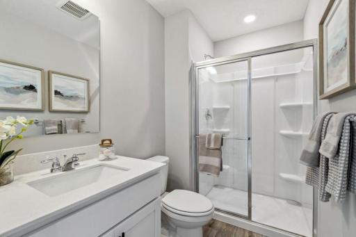 Hall bathroom upstairs services the last secondary bedroom. Photo of a model home, color & options will vary.