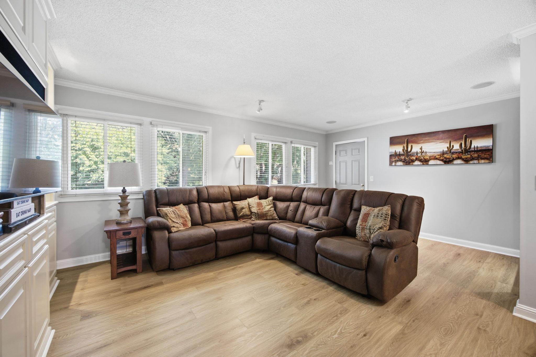 The living room is spacious and filled with natural light