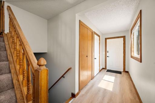 Entryway with coat closet and access to garage.