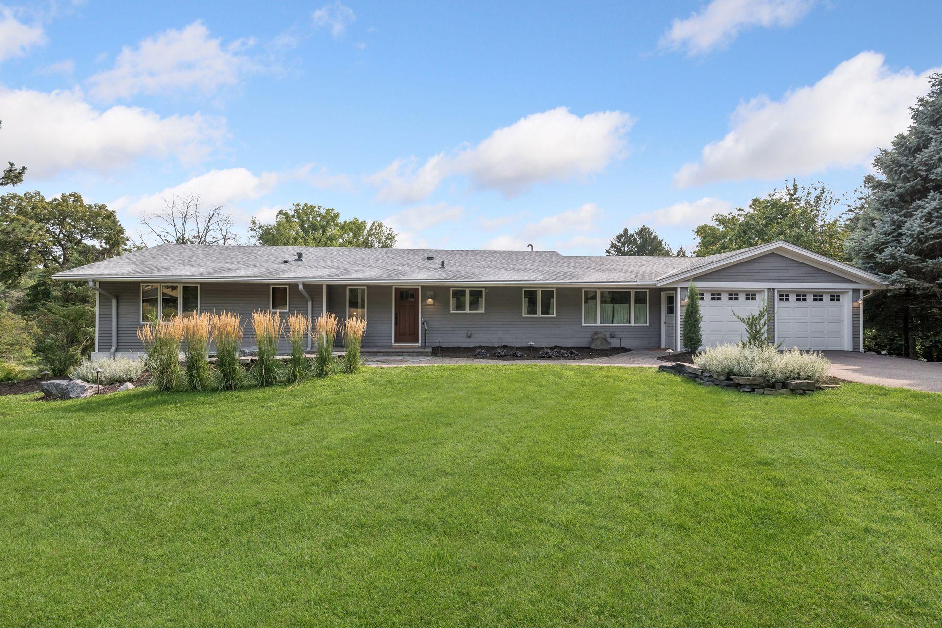 Outside, enjoy the privacy of the expansive lot with mature surroundings, paver walkway and patio, deck, and attached two-car garage.
