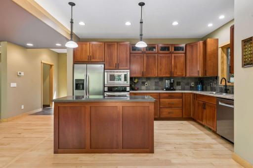 Pendant lighting over the center island and recessed can lights give the kitchen ample lighting.