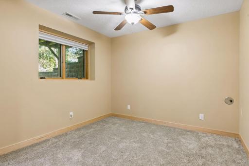 This bedroom in the lower level could also serve as a private home office space.