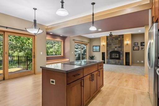 The kitchen flows into the dining and living areas with a full wall of windows to enjoy natural light and views of the private, wooded backyard.