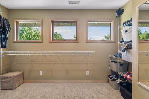 Spacious walk-in closet in the primary suite includes windows to provide natural sunlight.